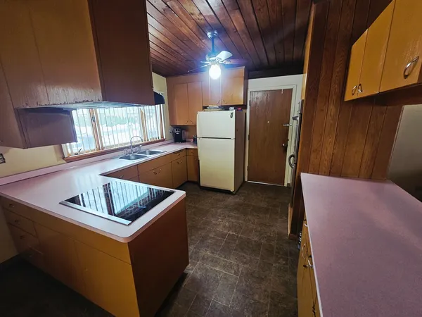 a view of a room with wooden floor and furniture