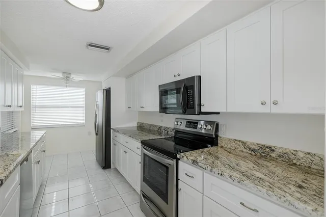 a kitchen with stainless steel appliances a refrigerator sink and microwave