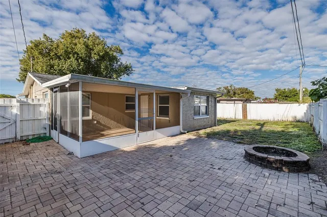a view of a yard in front of a house with large trees