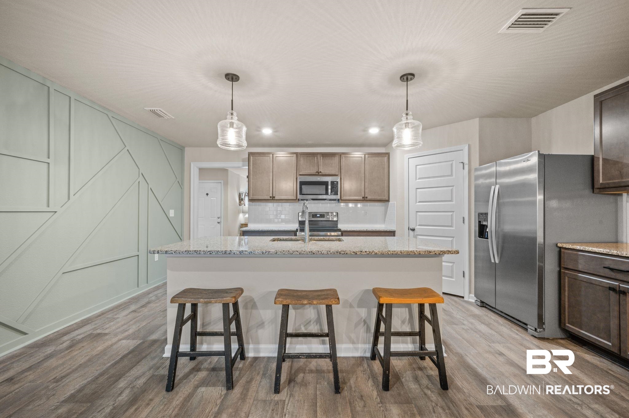 10306 Brodick Loop Spanish Fort, AL 36527 - Photo 7 of 35 Kitchen featuring a center island with sink, stainless steel appliances, light wood-type flooring, and sink