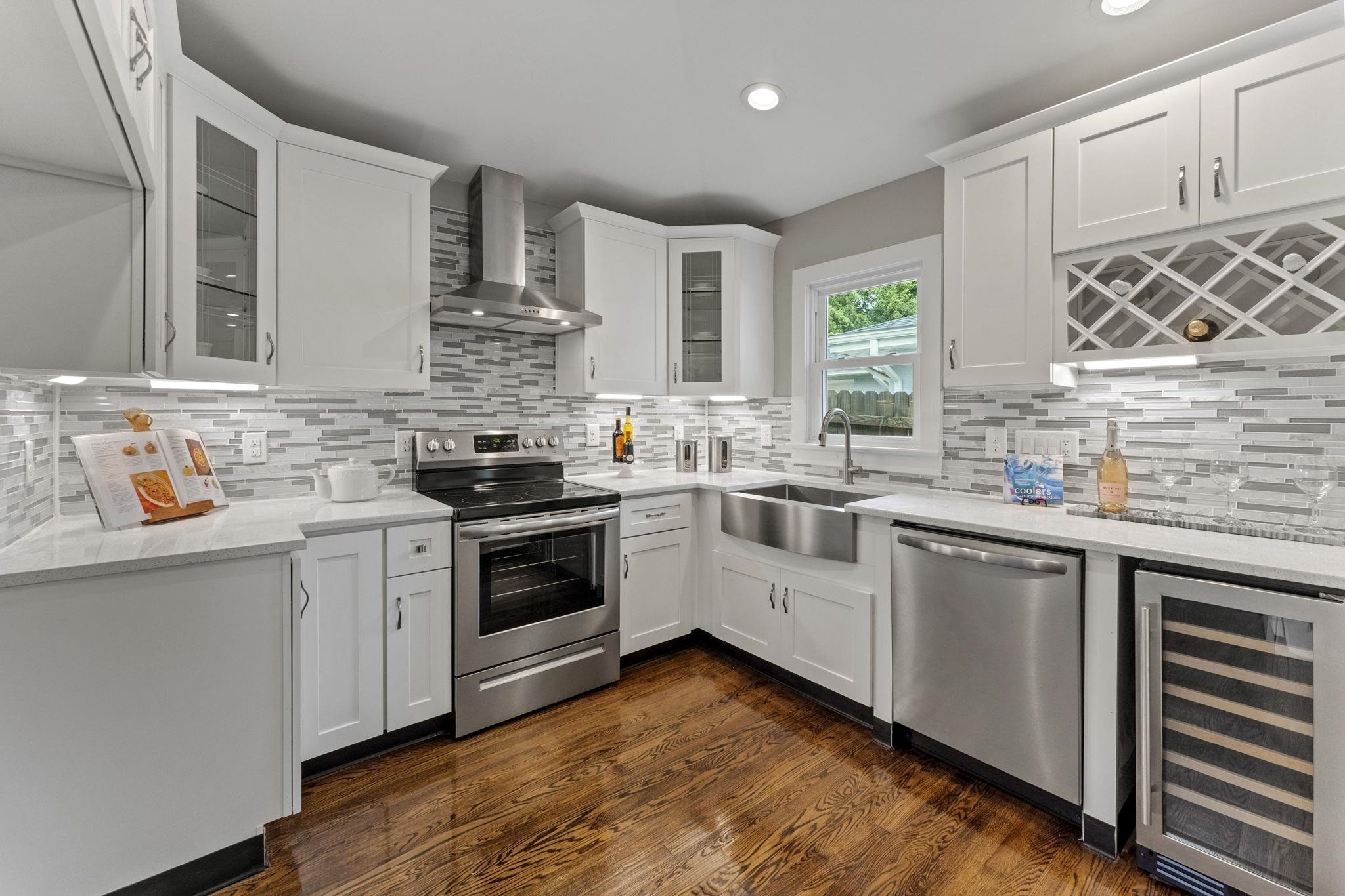 a kitchen with stainless steel appliances granite countertop a stove sink and cabinets