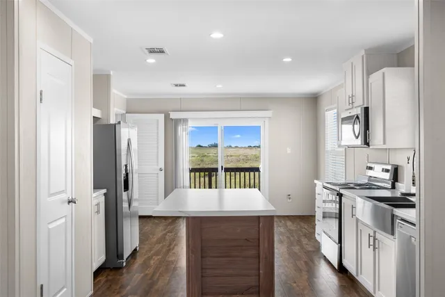 a kitchen with stainless steel appliances granite countertop a stove and a refrigerator