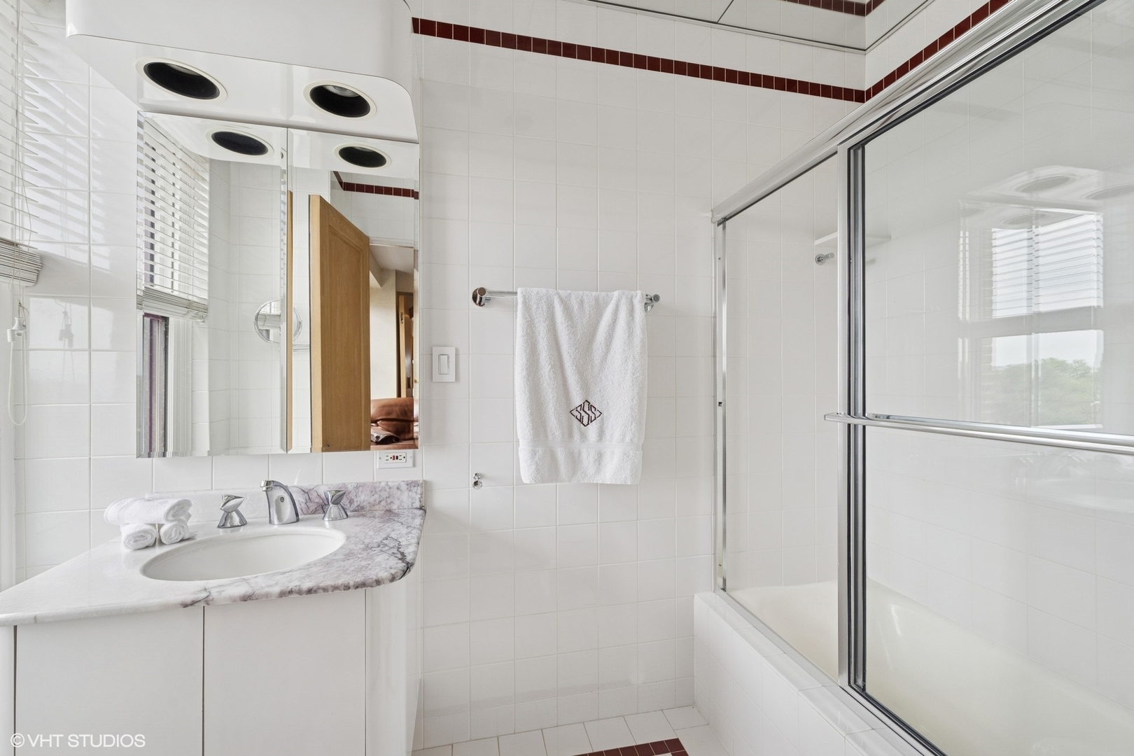 3500 North Lake Shore Drive, Unit 7C Chicago, IL 60657 - Photo 12 of 36 a bathroom with a sink and a mirror