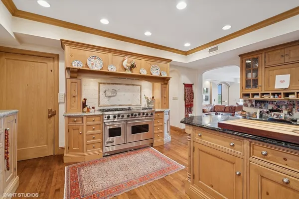 a kitchen with stainless steel appliances granite countertop a stove and cabinets