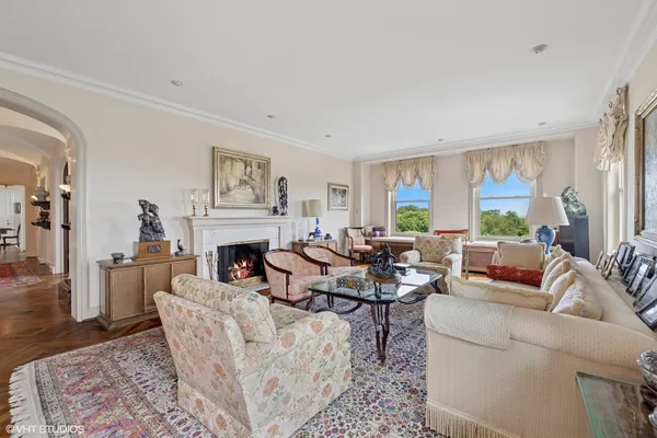 a living room with furniture large window and a fireplace
