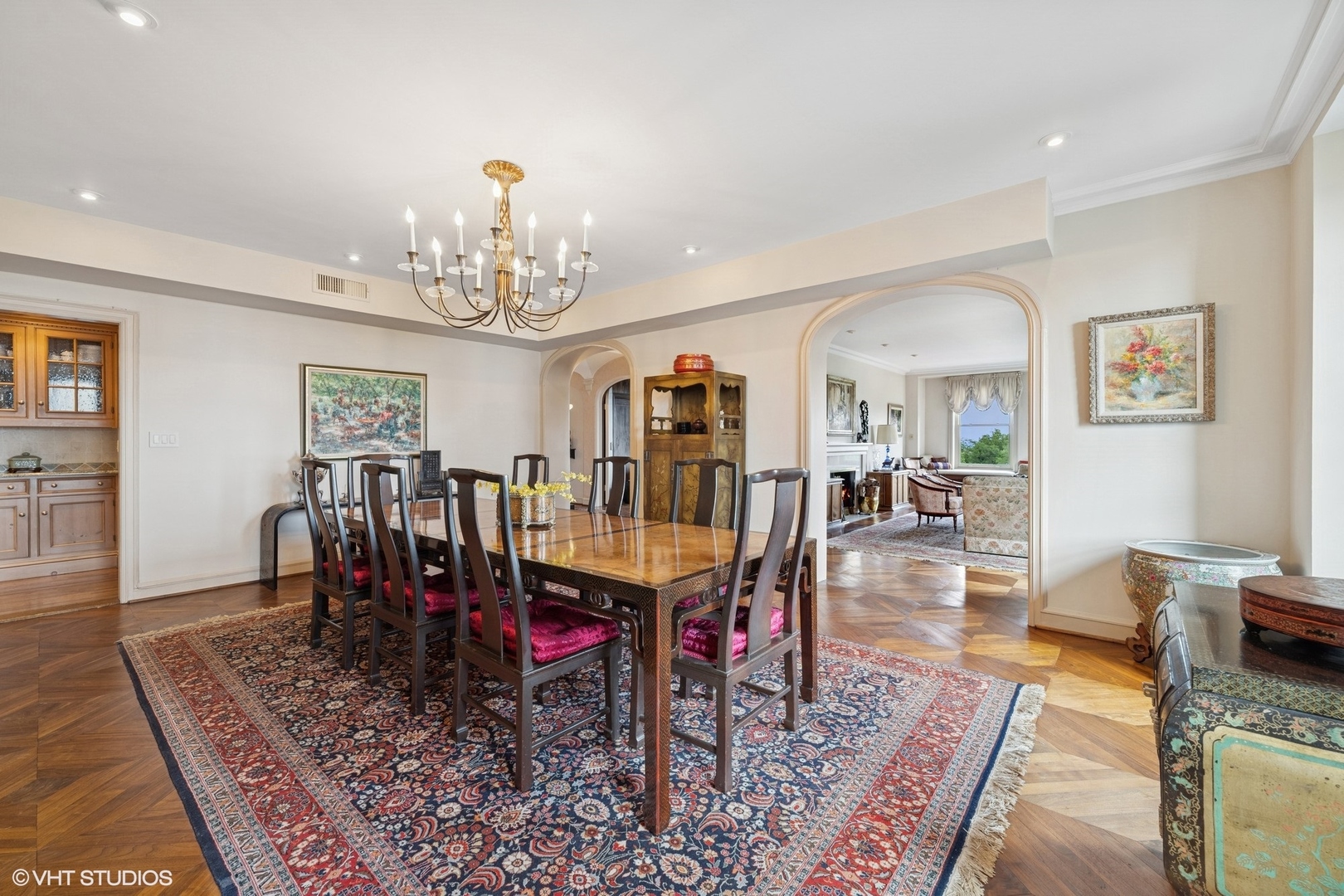 3500 North Lake Shore Drive, Unit 7C Chicago, IL 60657 - Photo 9 of 36 a dining room with wooden floor a chandelier a wooden table and chairs