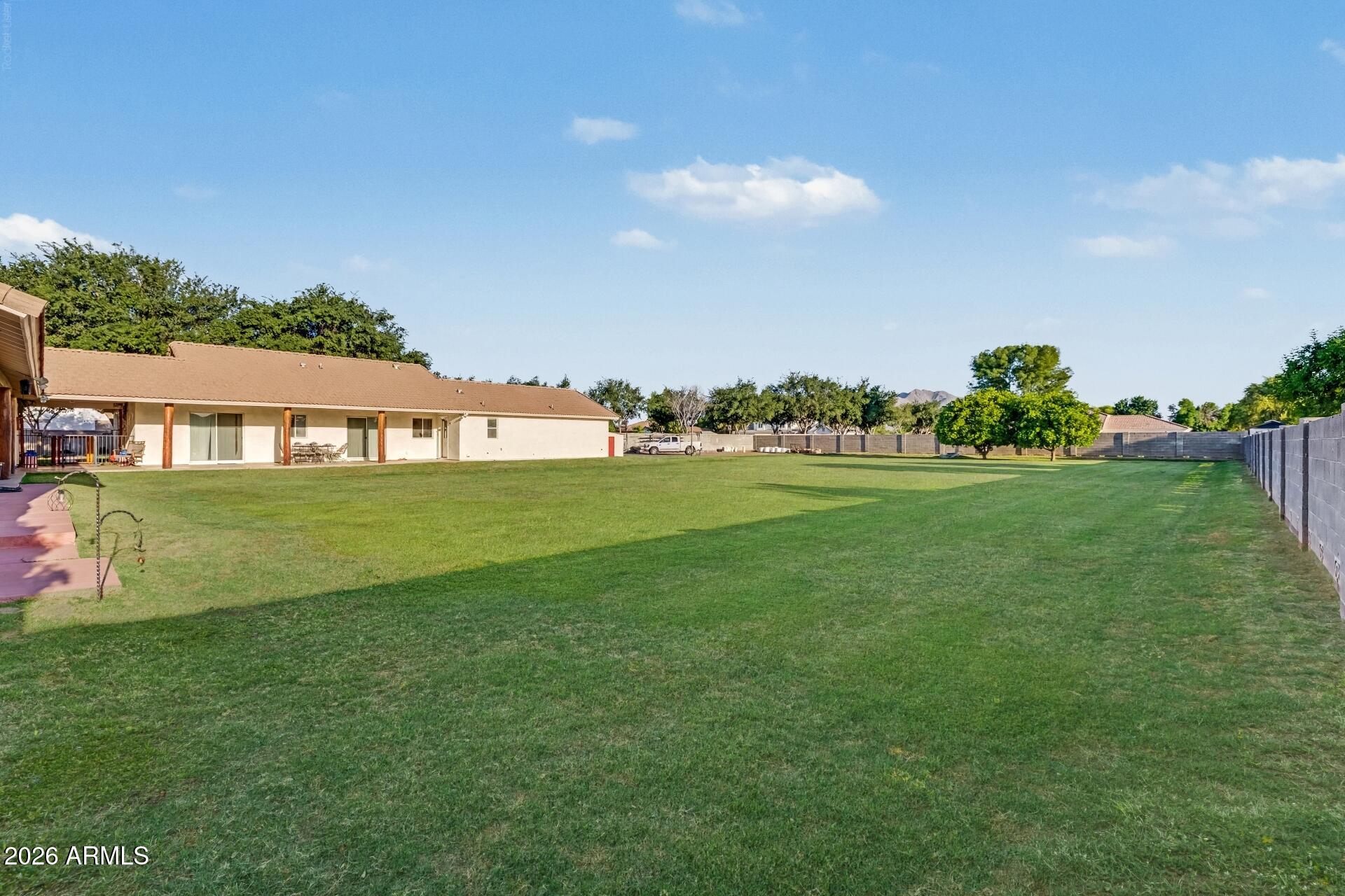 2593 East Ridgewood Lane Gilbert, AZ 85298 - Photo 19 of 23 a backyard of a house with lots of green space and garden