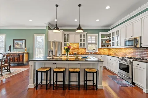 a living room with furniture a rug and a large window