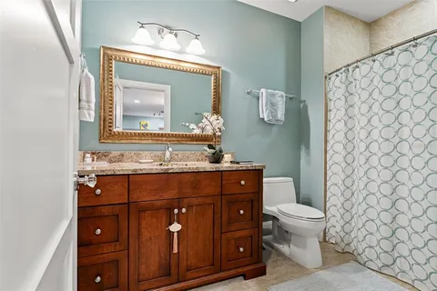 a view of a porch with chairs and potted plants