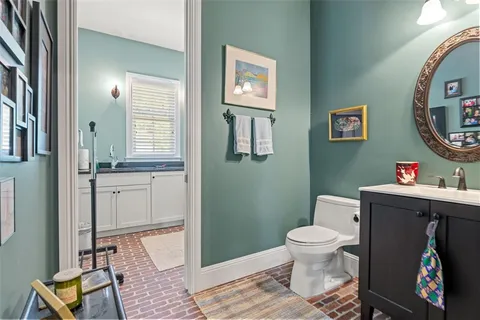 a view of swimming pool with seating space and trees in the background