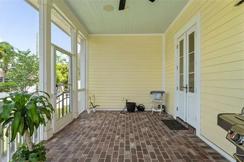 a front view of a house with a yard and potted plants