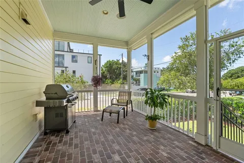 a front view of a house with a yard and potted plants