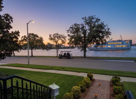 a large kitchen with granite countertop a sink and white stainless steel appliances