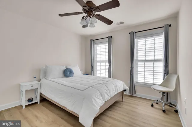a bedroom with a bed and a large window