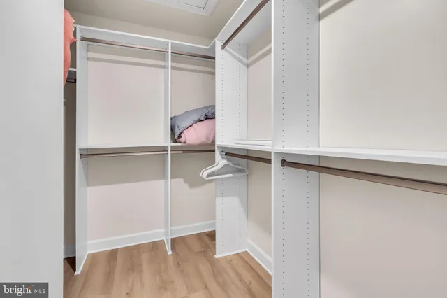 a view of staircase with lots of frames on wall and a window