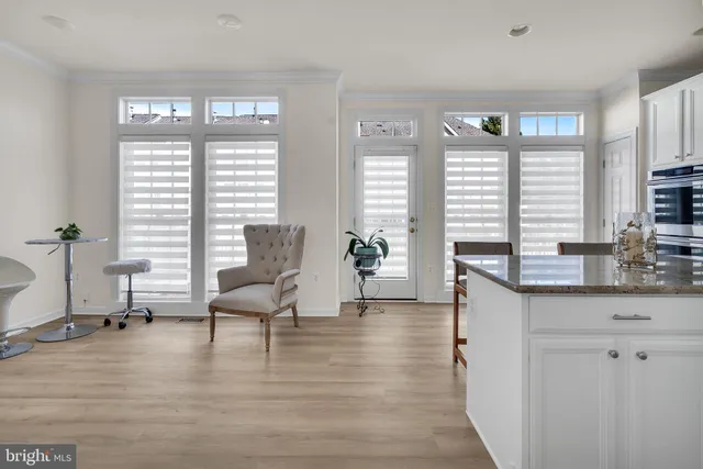 a living room with furniture and large windows
