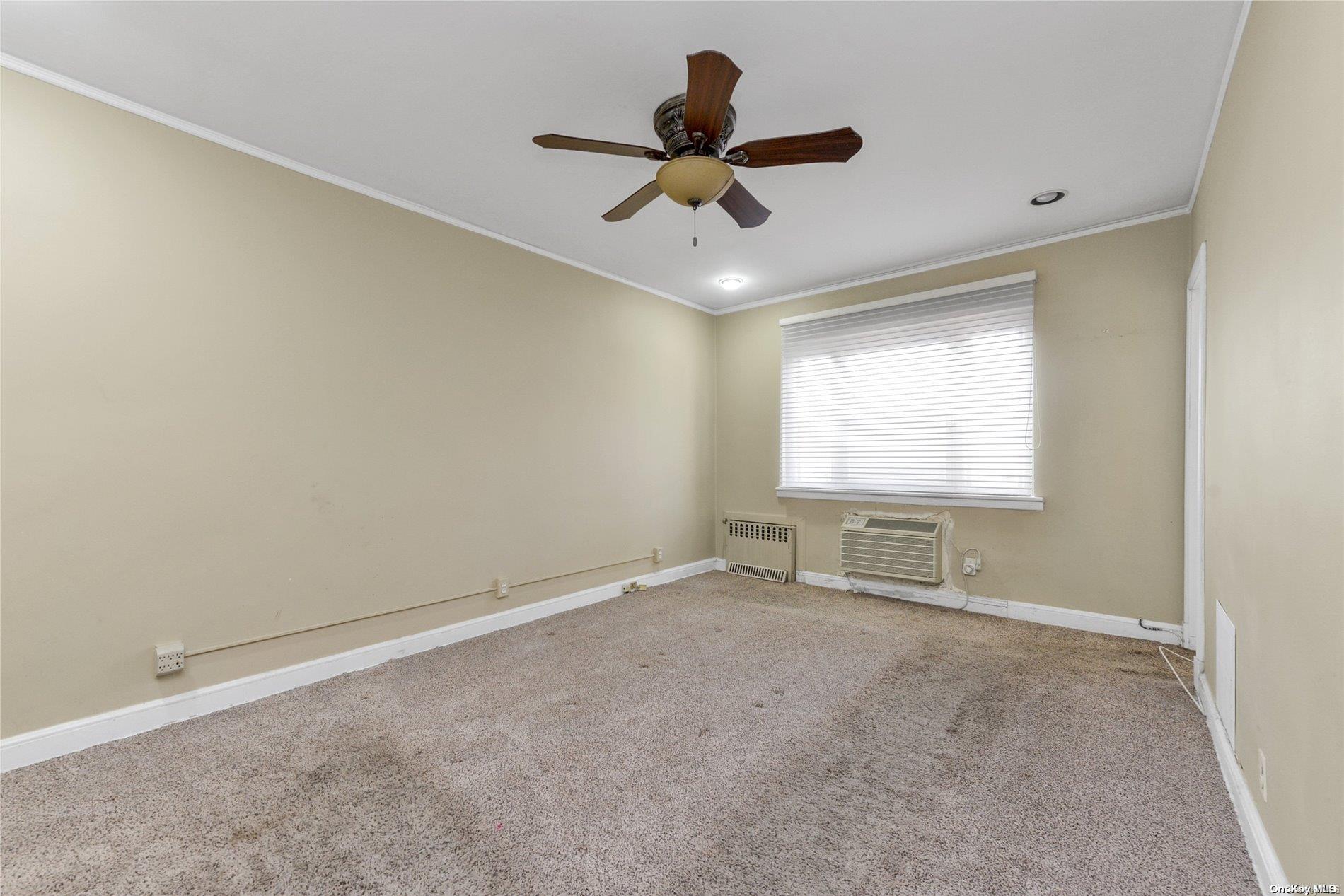 144-31 69th Road Queens, NY 11367 - Photo 11 of 21 a view of an empty room with a window