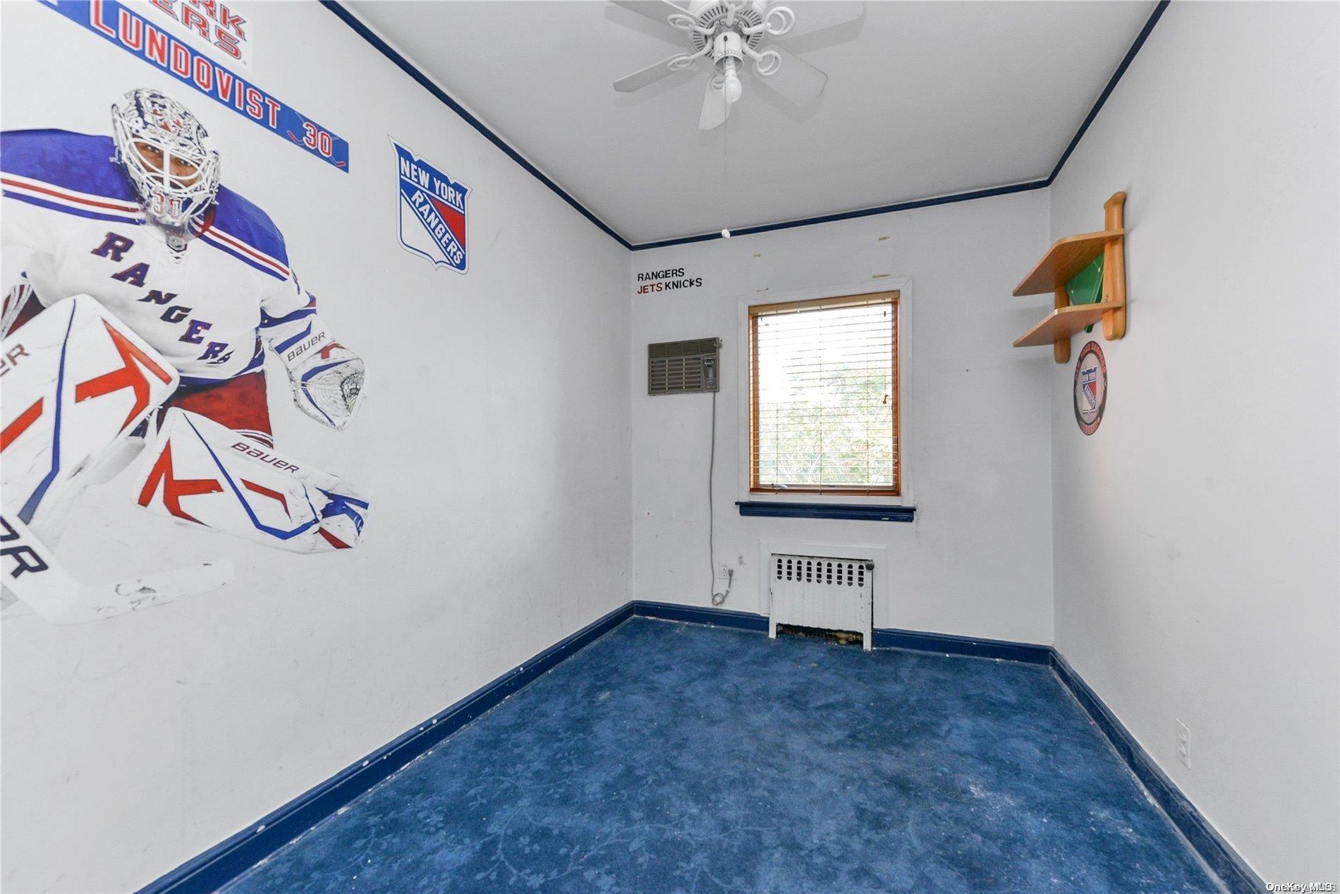 144-31 69th Road Queens, NY 11367 - Photo 13 of 21 an empty room with windows and fan