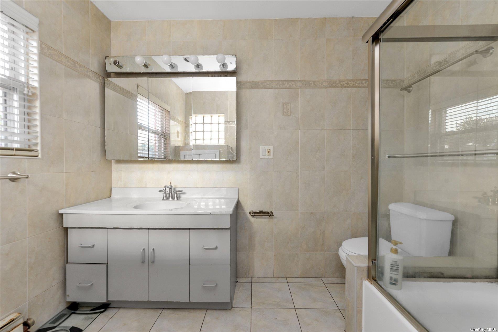 144-31 69th Road Queens, NY 11367 - Photo 15 of 21 a bathroom with a toilet sink and mirror