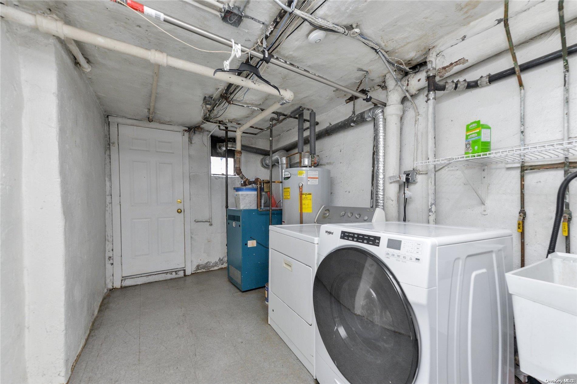 144-31 69th Road Queens, NY 11367 - Photo 18 of 21 a view of a utility room with dryer and washer