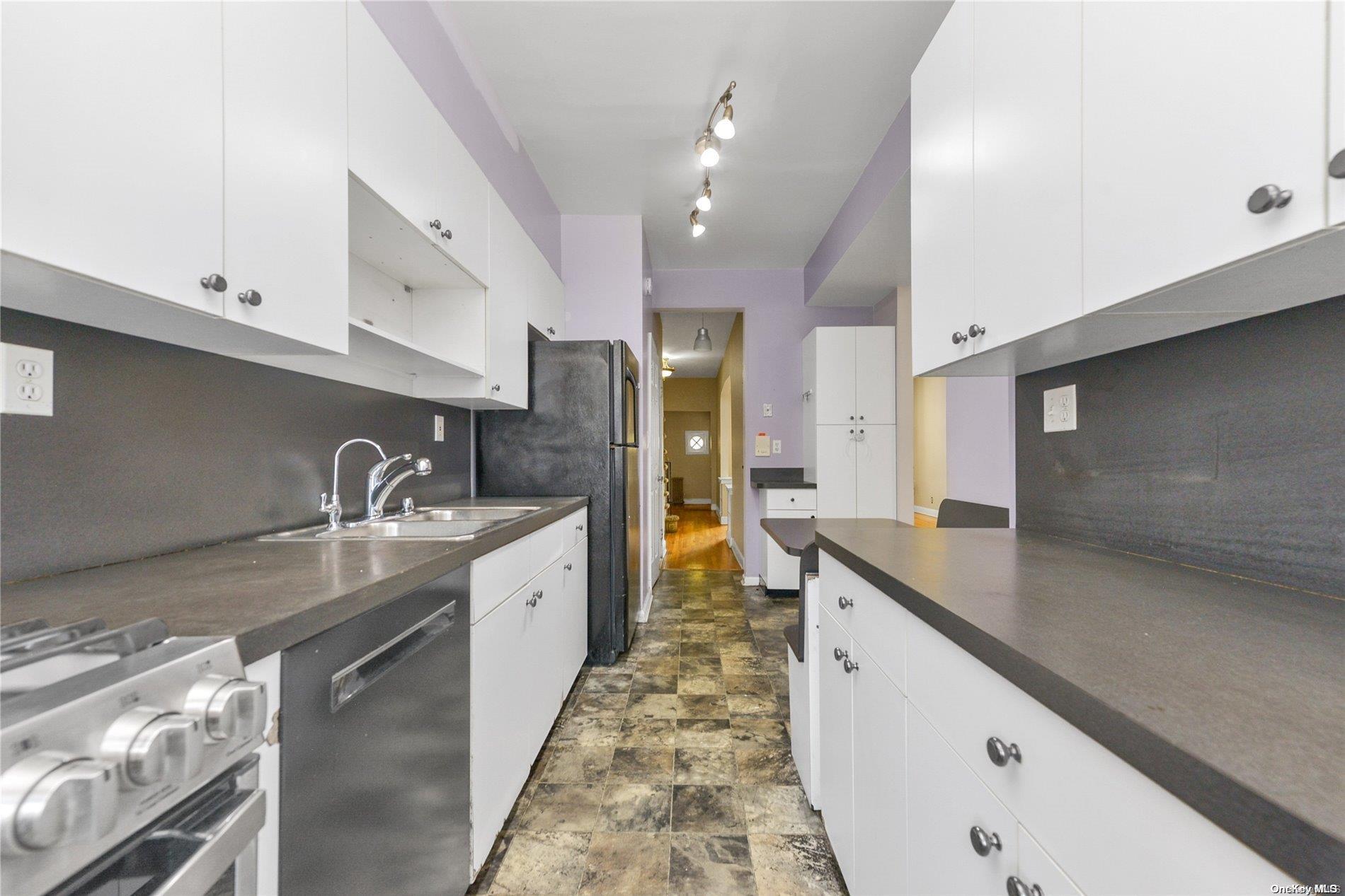 144-31 69th Road Queens, NY 11367 - Photo 7 of 21 a large kitchen with granite countertop a sink and cabinets