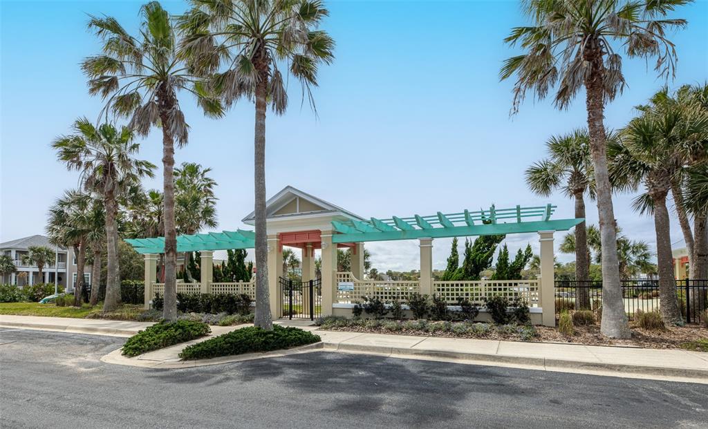 24 Sandy Beach Way Palm Coast, FL 32137 - Photo 9 of 17 a palm tree sitting in front of a house with a patio