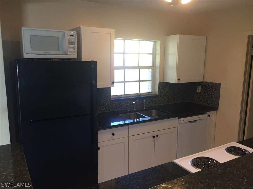 1545 Ransom Street Fort Myers, FL 33901 - Photo 6 of 25 a kitchen with a sink and a refrigerator