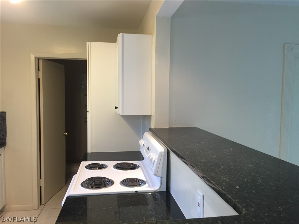 1545 Ransom Street Fort Myers, FL 33901 - Photo 8 of 25 a kitchen with a sink a stove top oven and cabinets