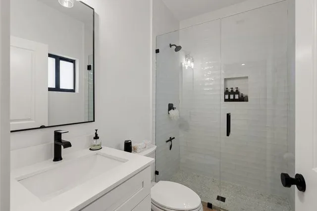 a bathroom with a sink toilet and shower