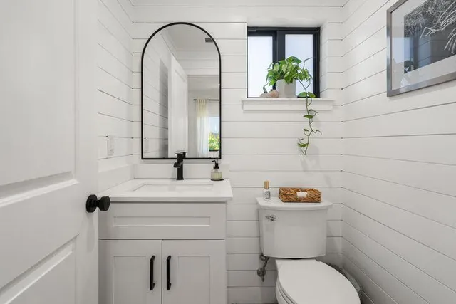 a bathroom with a sink a toilet and a mirror