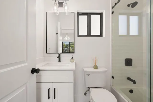 a bathroom with a sink toilet and mirror