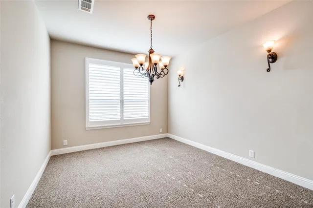 a view of a room with windows and chandelier