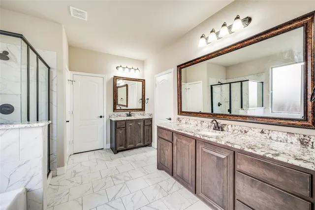 a large bathroom with a sink mirror and a shower