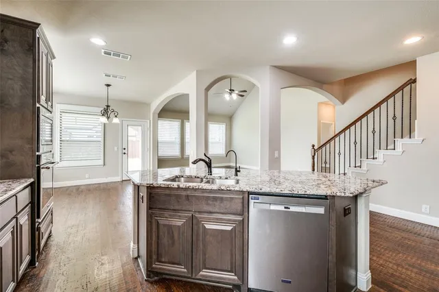 a bathroom with a granite countertop sink a large mirror and shower