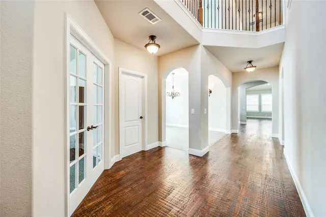 a view of a hallway view with wooden floor and staircase