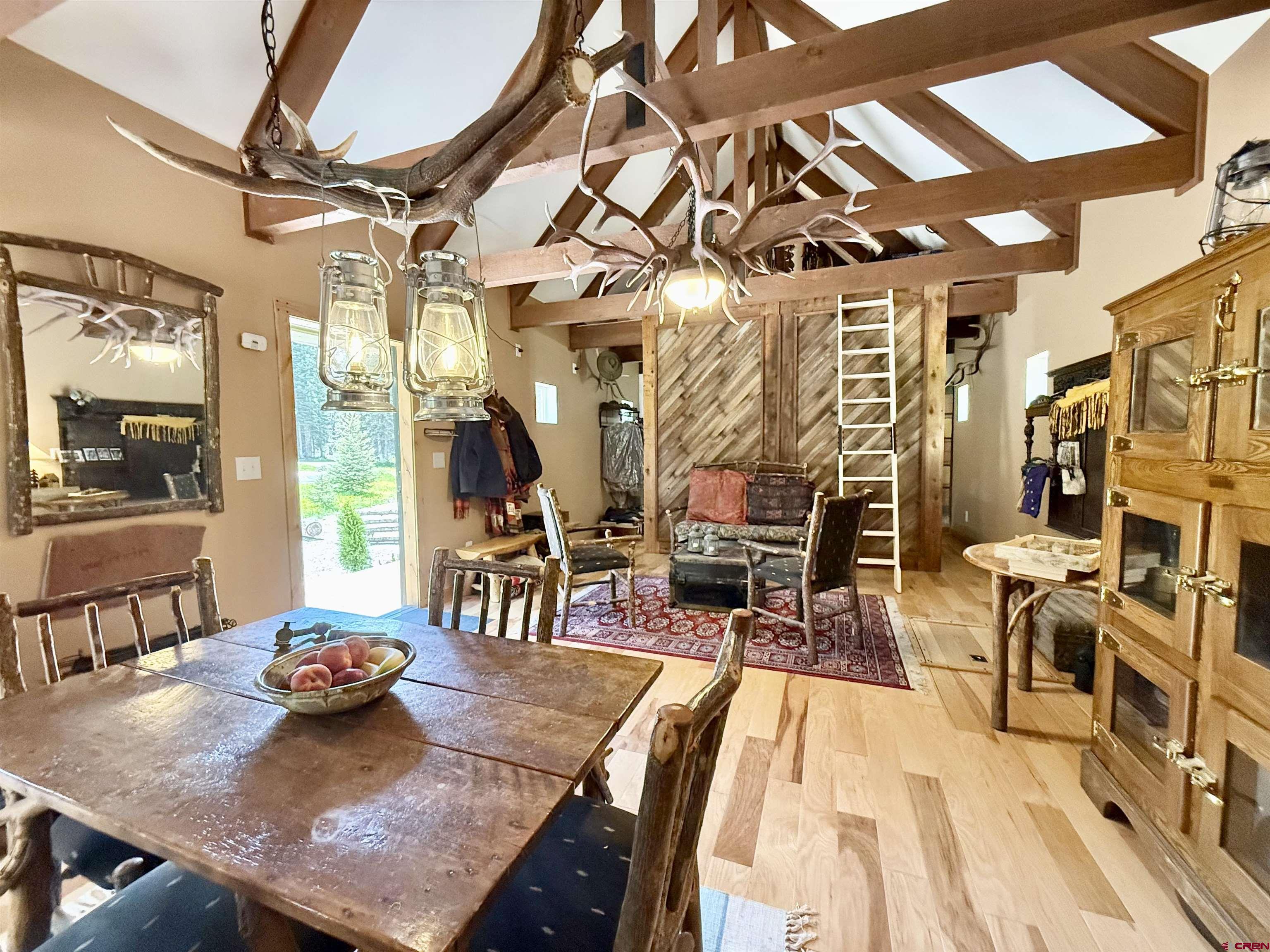 45521 Divide Road Montrose, CO 81403 - Photo 11 of 39 a view of a dining room with furniture and wooden floor