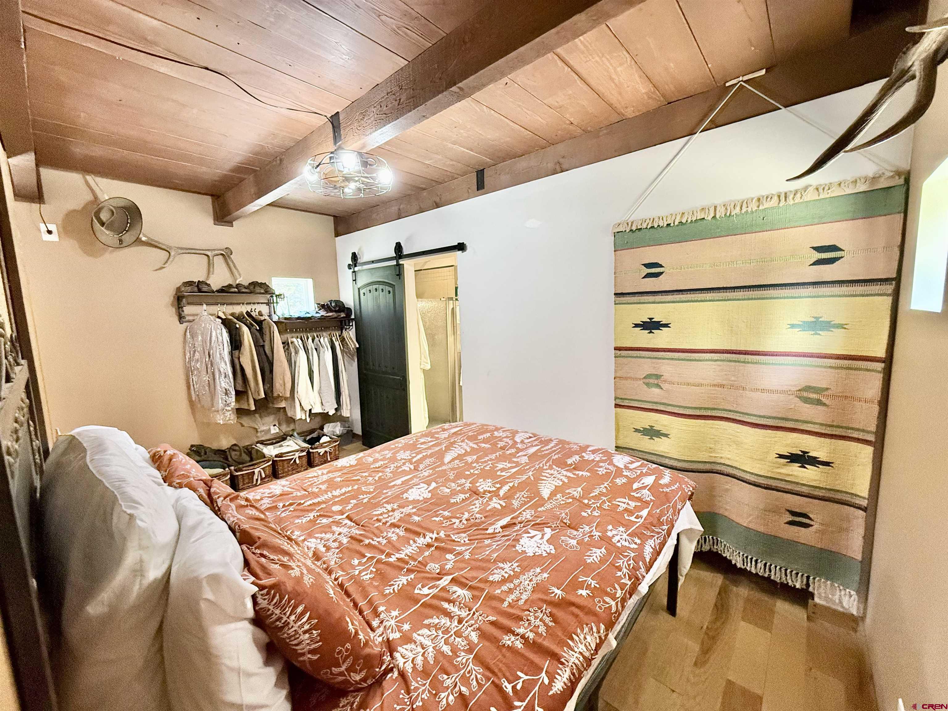45521 Divide Road Montrose, CO 81403 - Photo 17 of 39 a bed room with a bed and a mirror