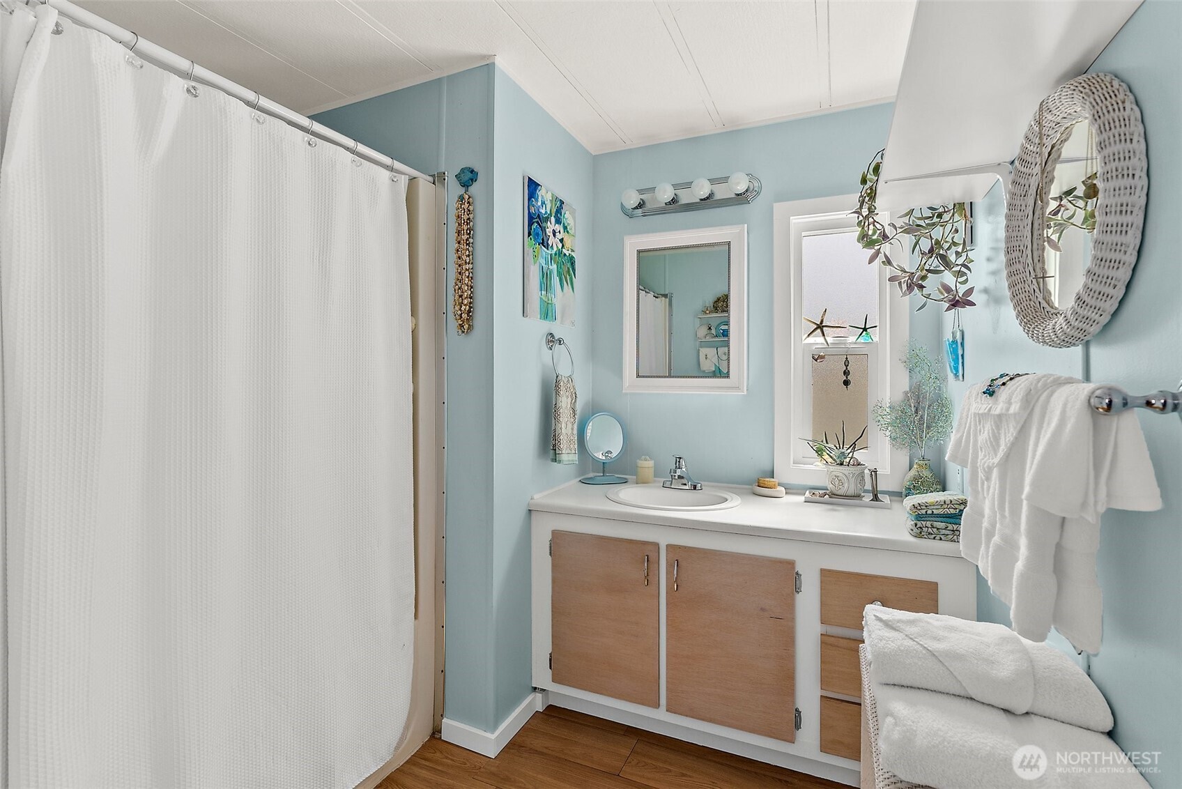 1050 Howard Street, Unit 9 Raymond, WA 98577 - Photo 13 of 20 a en suite bathroom with a granite countertop sink and a mirror