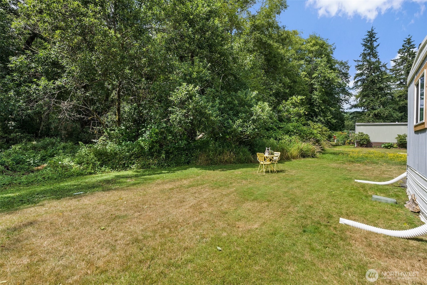 1050 Howard Street, Unit 9 Raymond, WA 98577 - Photo 20 of 20 a backyard of a house with yard and trampoline