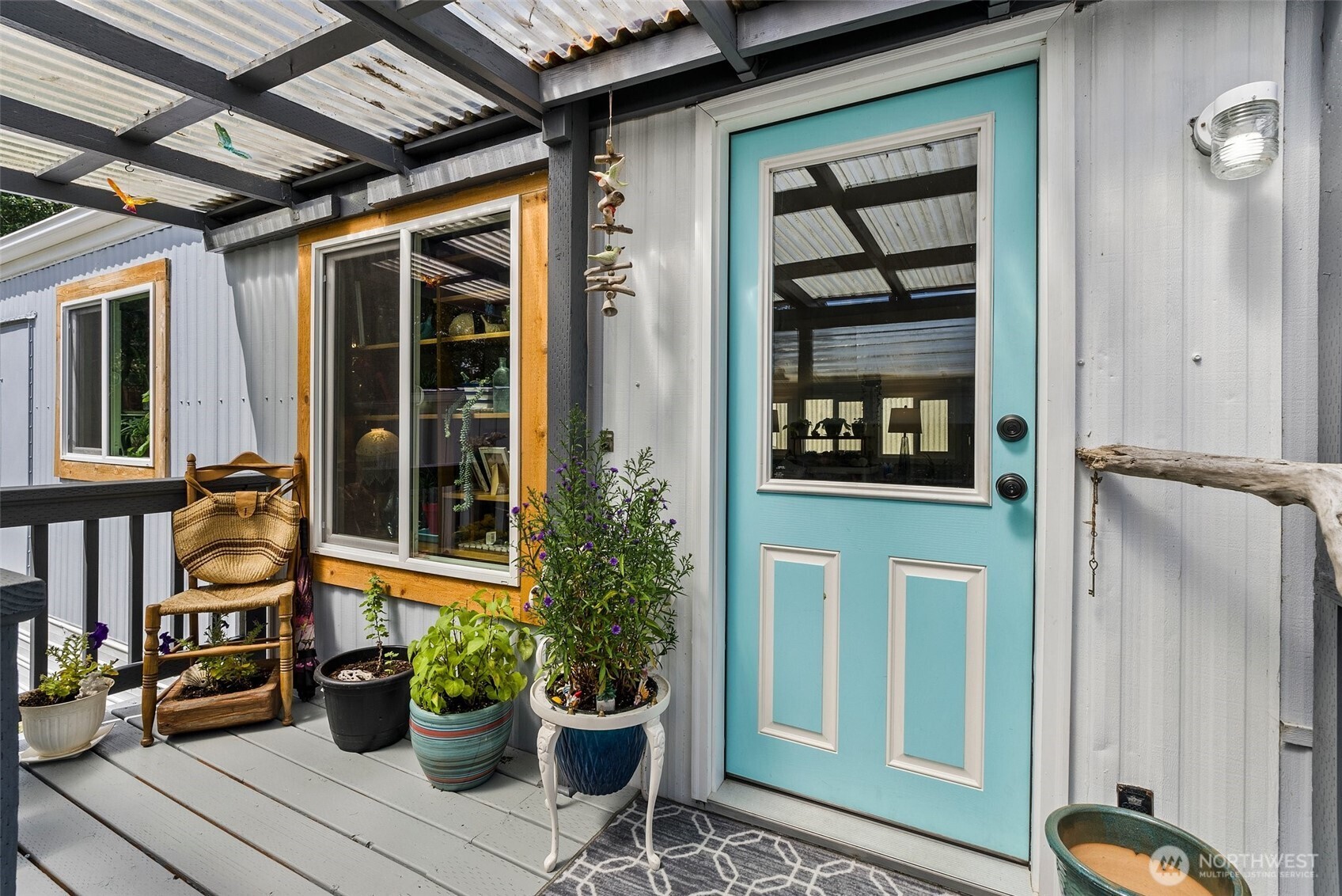 1050 Howard Street, Unit 9 Raymond, WA 98577 - Photo 5 of 20 a view of a house with a potted plant and floor to ceiling windows