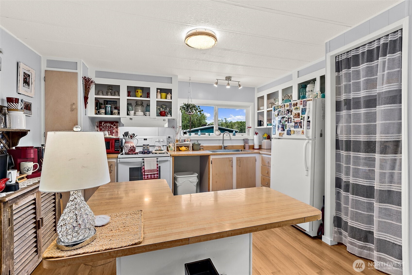 1050 Howard Street, Unit 9 Raymond, WA 98577 - Photo 8 of 20 a room with stainless steel appliances kitchen island granite countertop a sink and cabinets