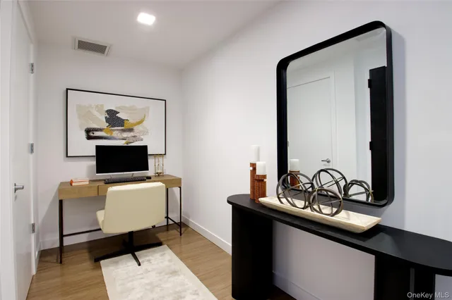 a living room with furniture and a mirror