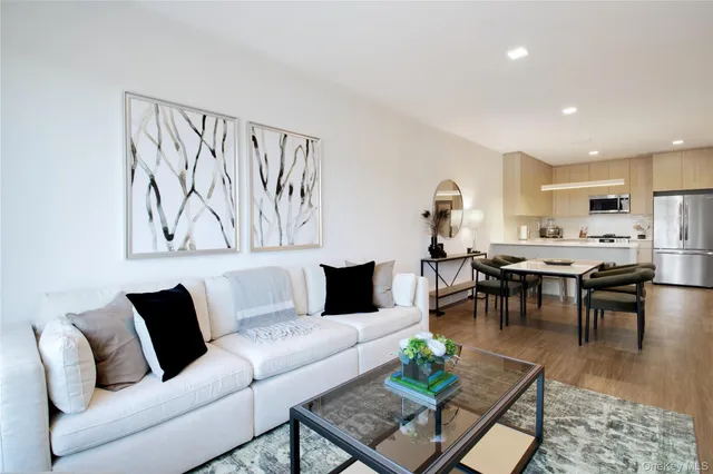 a living room with furniture kitchen view and a table