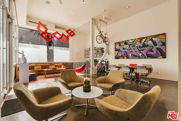 a living room with furniture and flowers