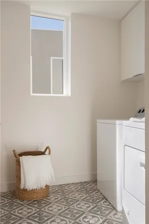 an entryway with wooden floor and a mirror