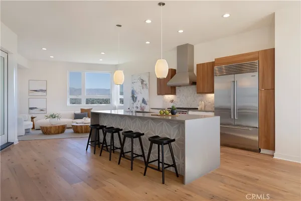 a large kitchen with a table and chairs