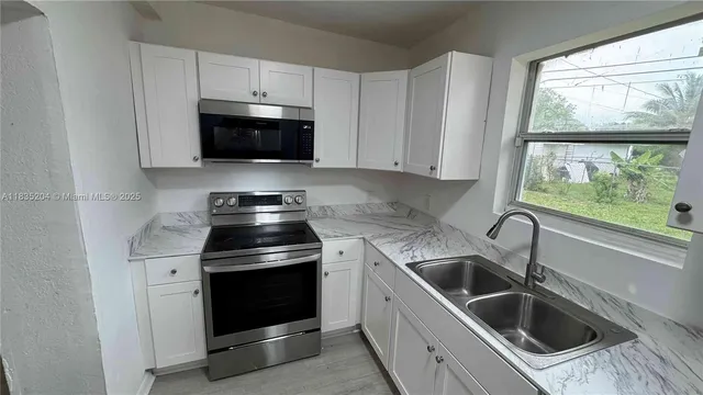 a kitchen with a stove and a sink