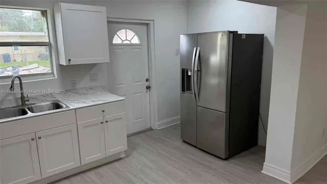a kitchen with cabinets and stainless steel appliances