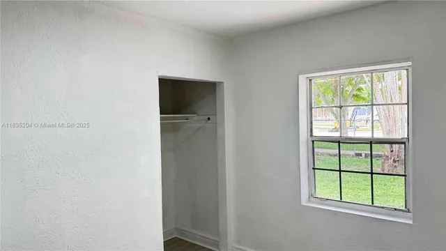 a view of an empty room with a window