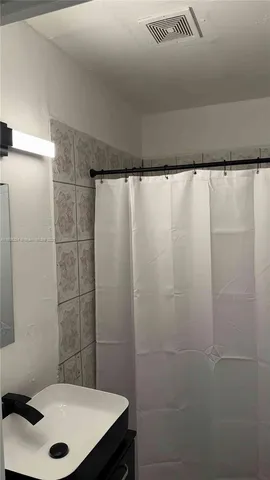 a bathroom with a sink and a shower